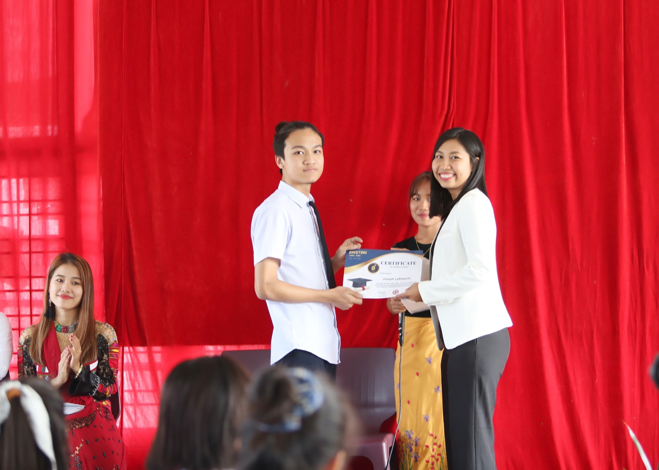 An EPS student receiving a certificate